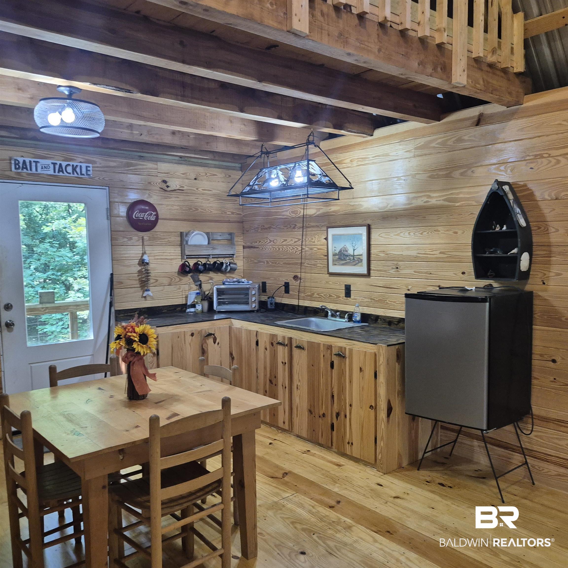 0 Eureka Landing Road Uriah, AL 36480 - Photo 22 of 27 Wood-finish shiplap walls and flooring complement the wooden cabinetry and exposed ceiling beams