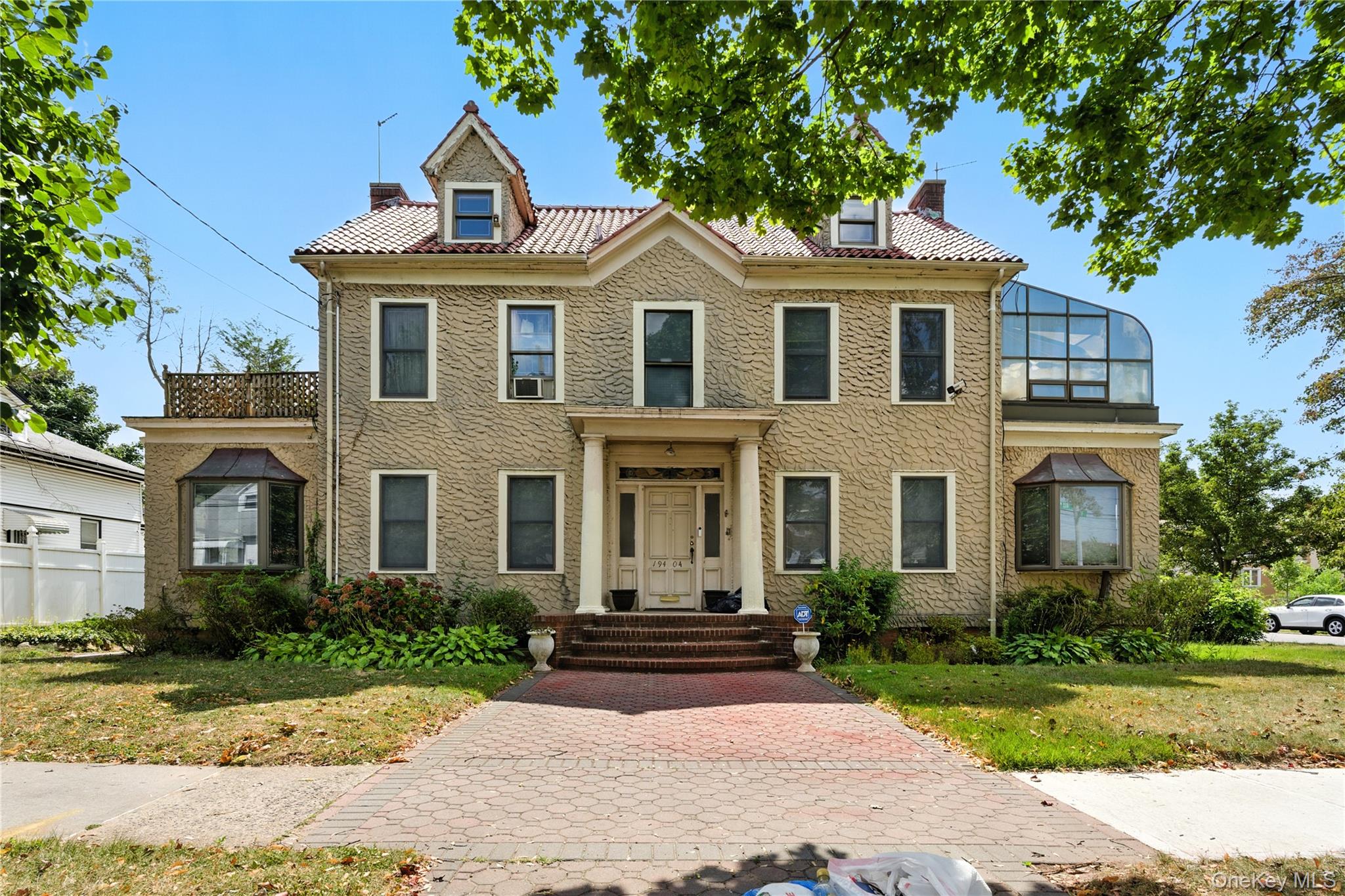 a front view of a house with a yard and trees