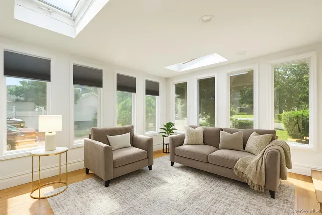 a living room with furniture and large windows