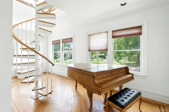 an empty room with windows and cabinet