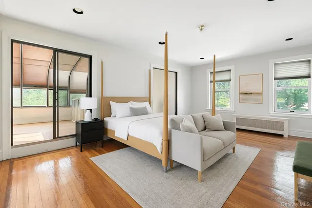 a living room with furniture and a floor to ceiling window