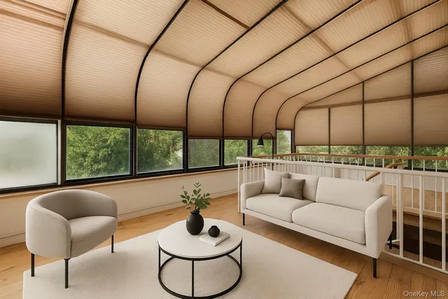 a livingroom with furniture wooden floor and a ceiling fan