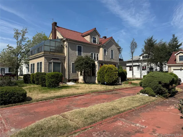 a front view of a house with a garden