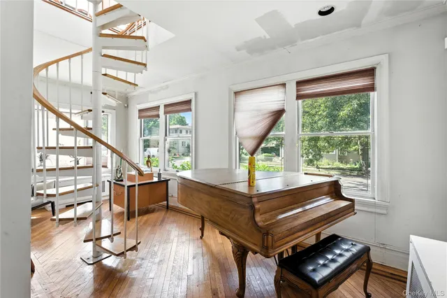 a room with wooden floor and windows