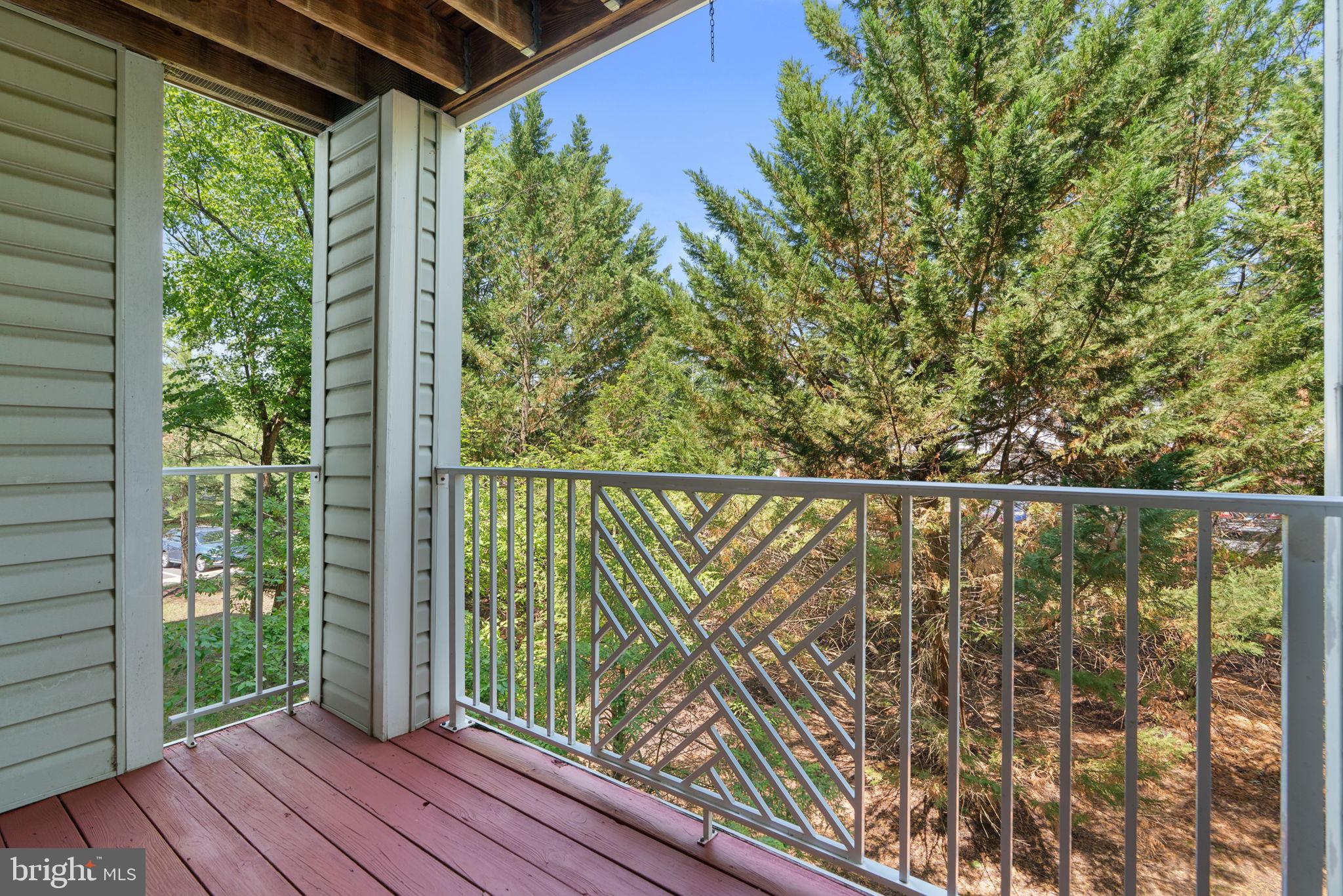 2444 Blue Spring Court, Unit 203 Odenton, MD 21113 - Photo 28 of 36 a view of a balcony with wooden floor