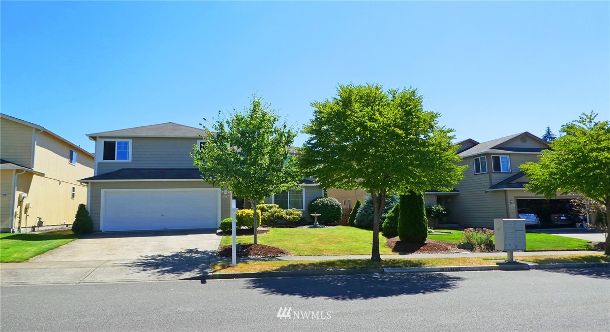 2513 Hidden Springs Loop Southeast Lacey, WA 98503 - Photo 1 of 40 a front view of a house with a yard and garage