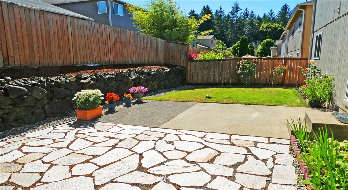 2513 Hidden Springs Loop Southeast Lacey, WA 98503 - Photo 17 of 40 a view of a backyard with plants and a bench