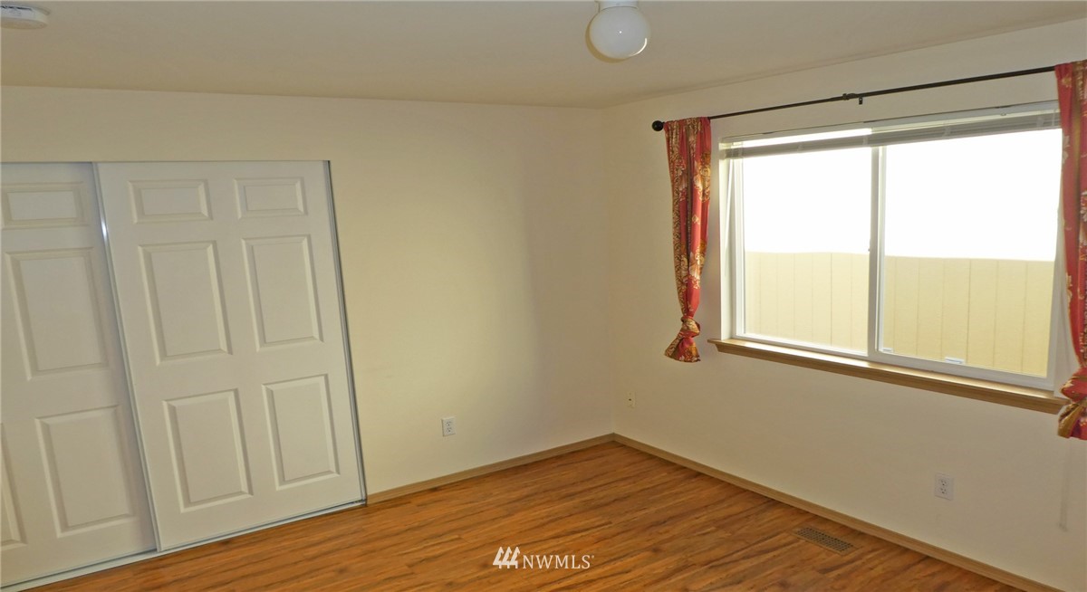 2513 Hidden Springs Loop Southeast Lacey, WA 98503 - Photo 18 of 40 a view of empty room with wooden floor and fan
