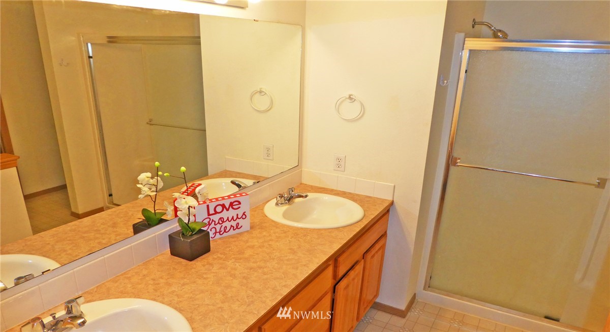 2513 Hidden Springs Loop Southeast Lacey, WA 98503 - Photo 26 of 40 a bathroom with a sink and a mirror