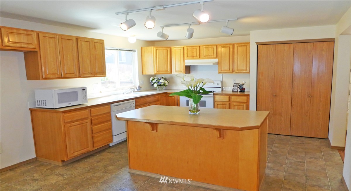 2513 Hidden Springs Loop Southeast Lacey, WA 98503 - Photo 7 of 40 a kitchen with stainless steel appliances granite countertop a sink a stove and a refrigerator