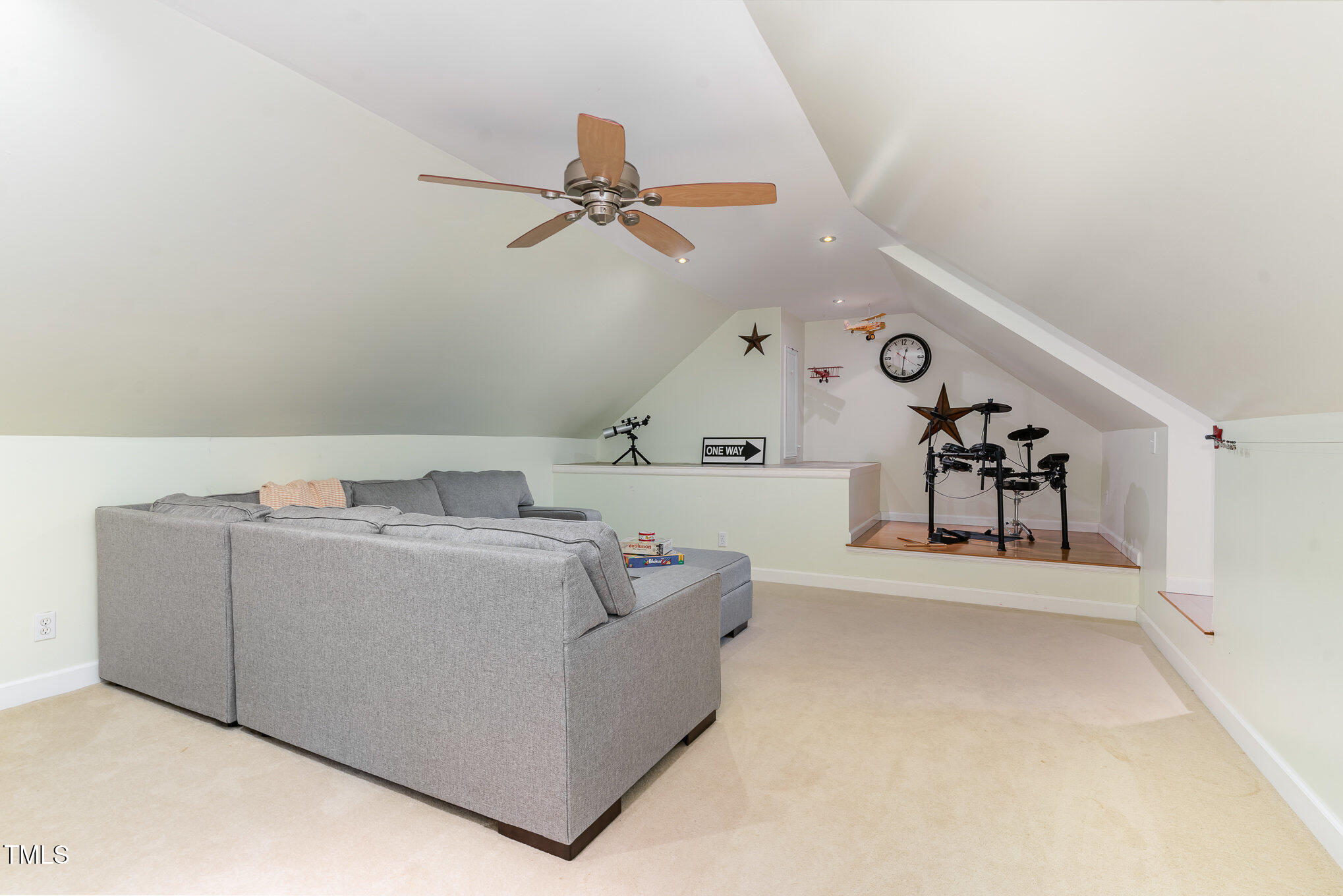 12709 Timberlane Court Raleigh, NC 27613 - Photo 26 of 44 Finished attic with newer carpet, newer sofa (conveys), mini-split HVAC, ready for game night, karaoke and a retreat for kids and parents alone times. (Non-permitted)