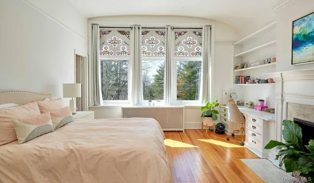 a spacious bedroom with a bed and a large window
