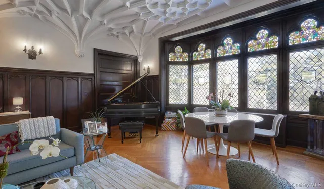 a living room with furniture and a floor to ceiling window