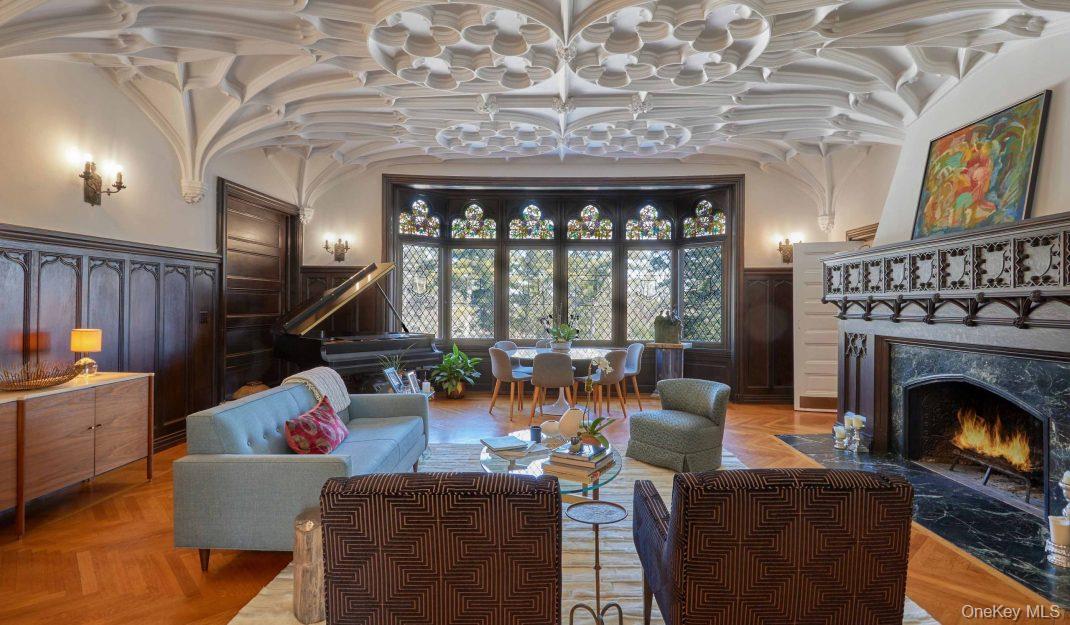 61 Crows Nest Road, Unit 6 Tuxedo Park, NY 10987 - Photo 4 of 14 a living room with furniture a fireplace and a floor to ceiling window