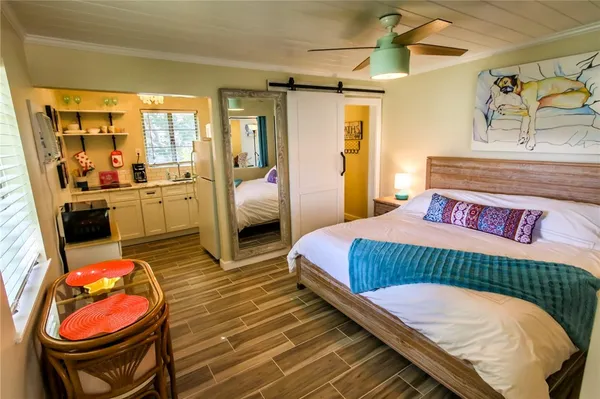 a bed room with a bed and a chandelier