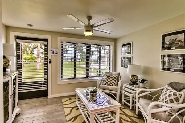 a view of a dining room with furniture large windows and wooden floor