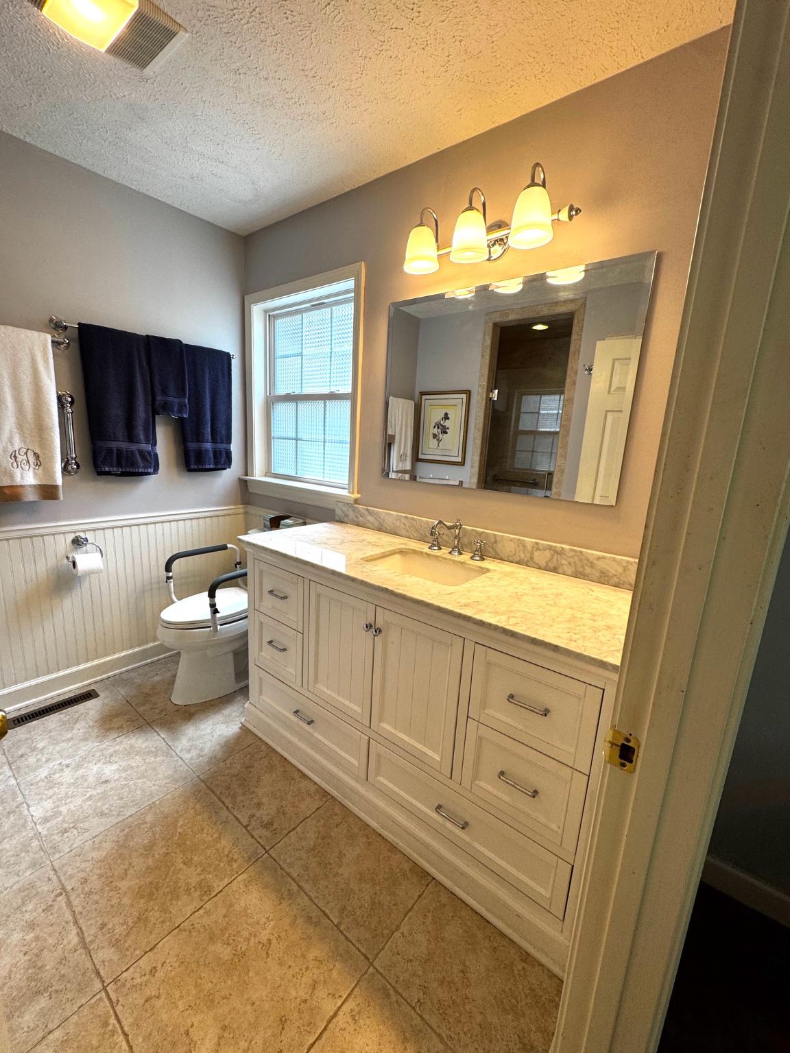 521 Painter Point Road Kilmarnock, VA 22482 - Photo 31 of 52 a large bathroom with a sink and a large mirror