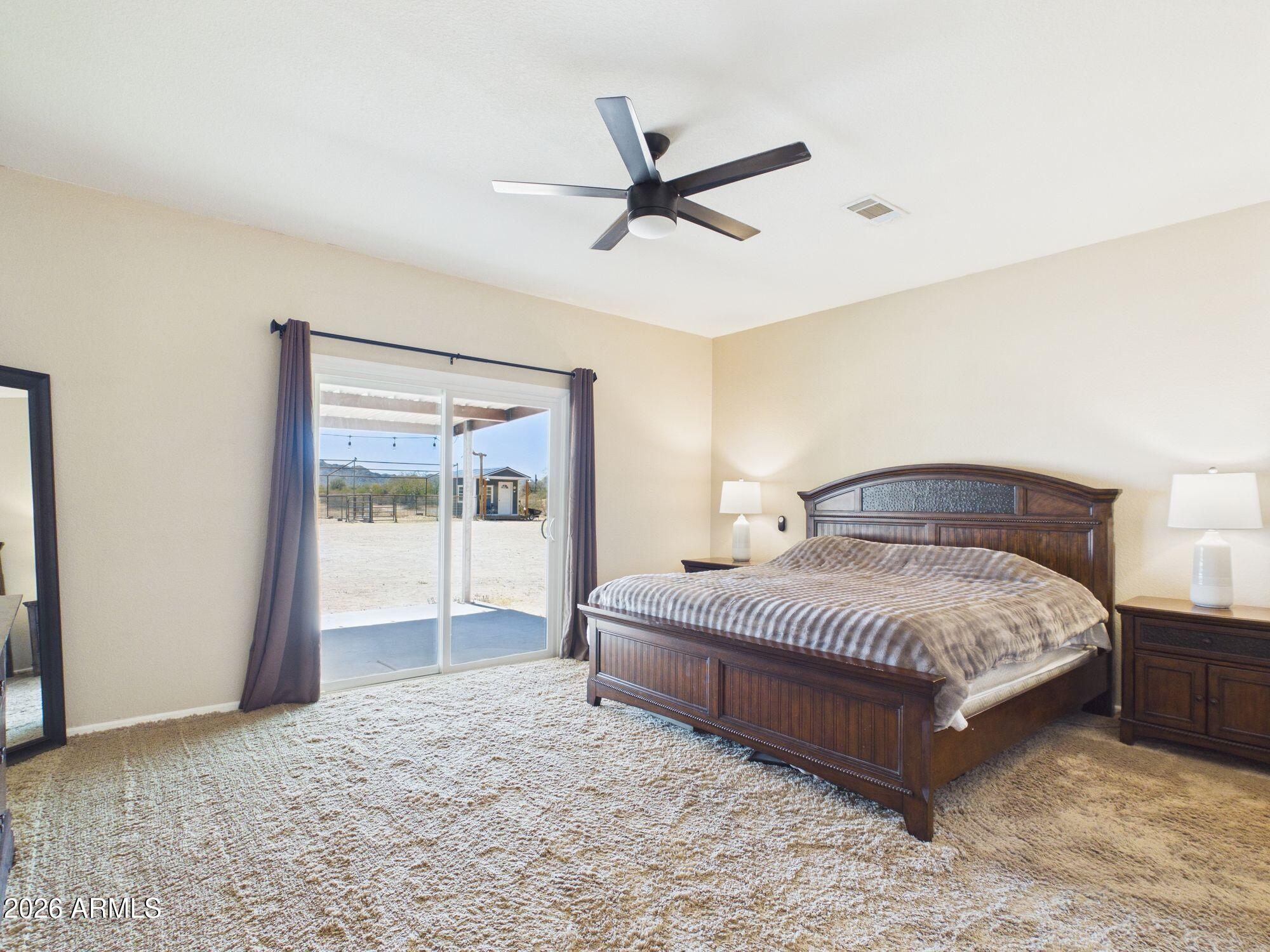 51491 West Dune Shadow Road Maricopa, AZ 85139 - Photo 11 of 33 a spacious bedroom with a bed and window