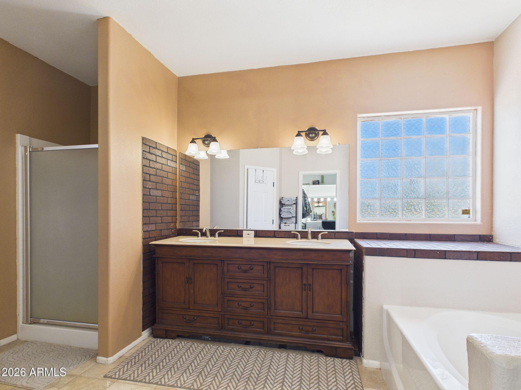 51491 West Dune Shadow Road Maricopa, AZ 85139 - Photo 14 of 33 a bathroom with a sink and a mirror
