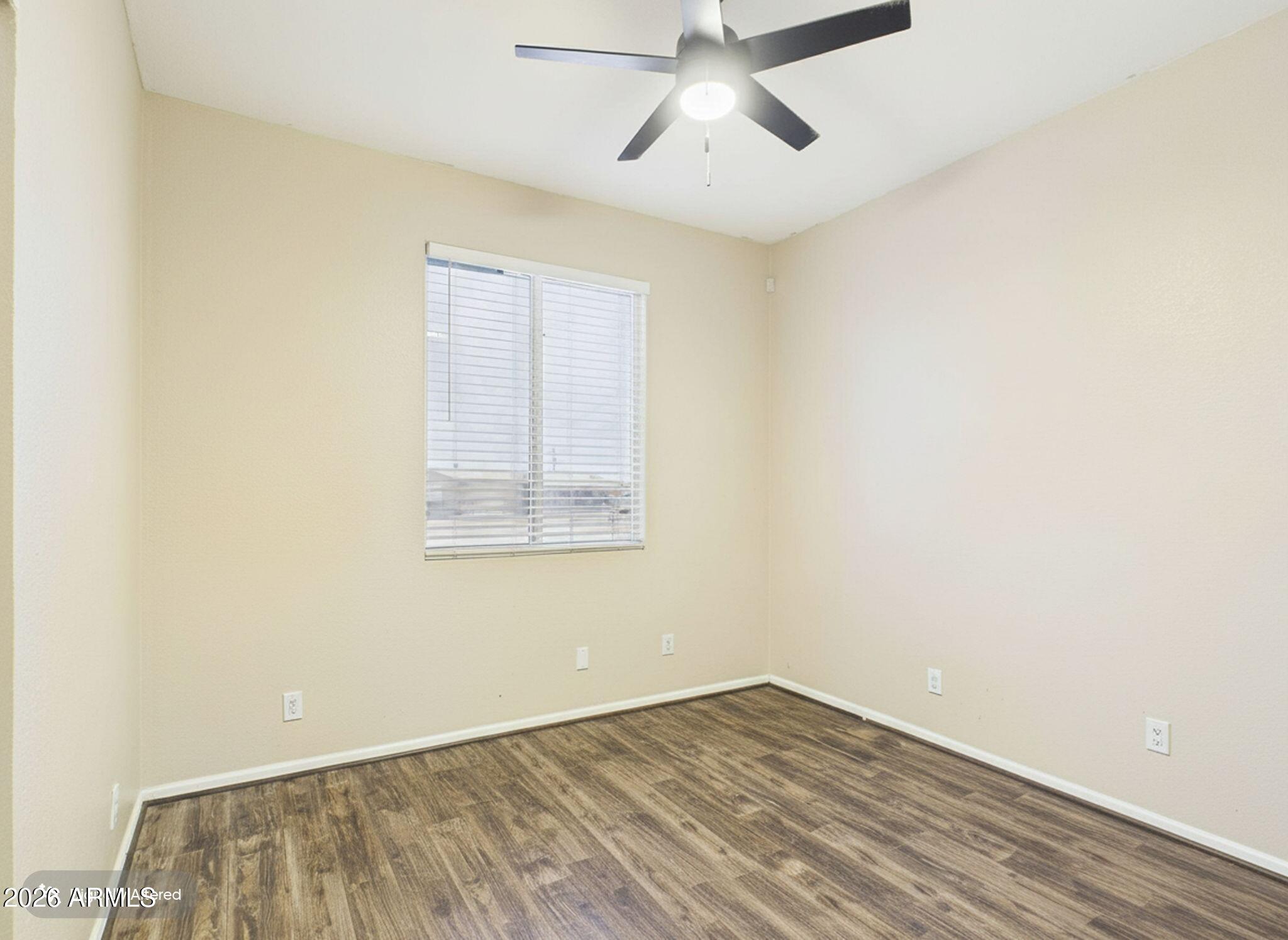 51491 West Dune Shadow Road Maricopa, AZ 85139 - Photo 16 of 33 an empty room with a window and ceiling fan