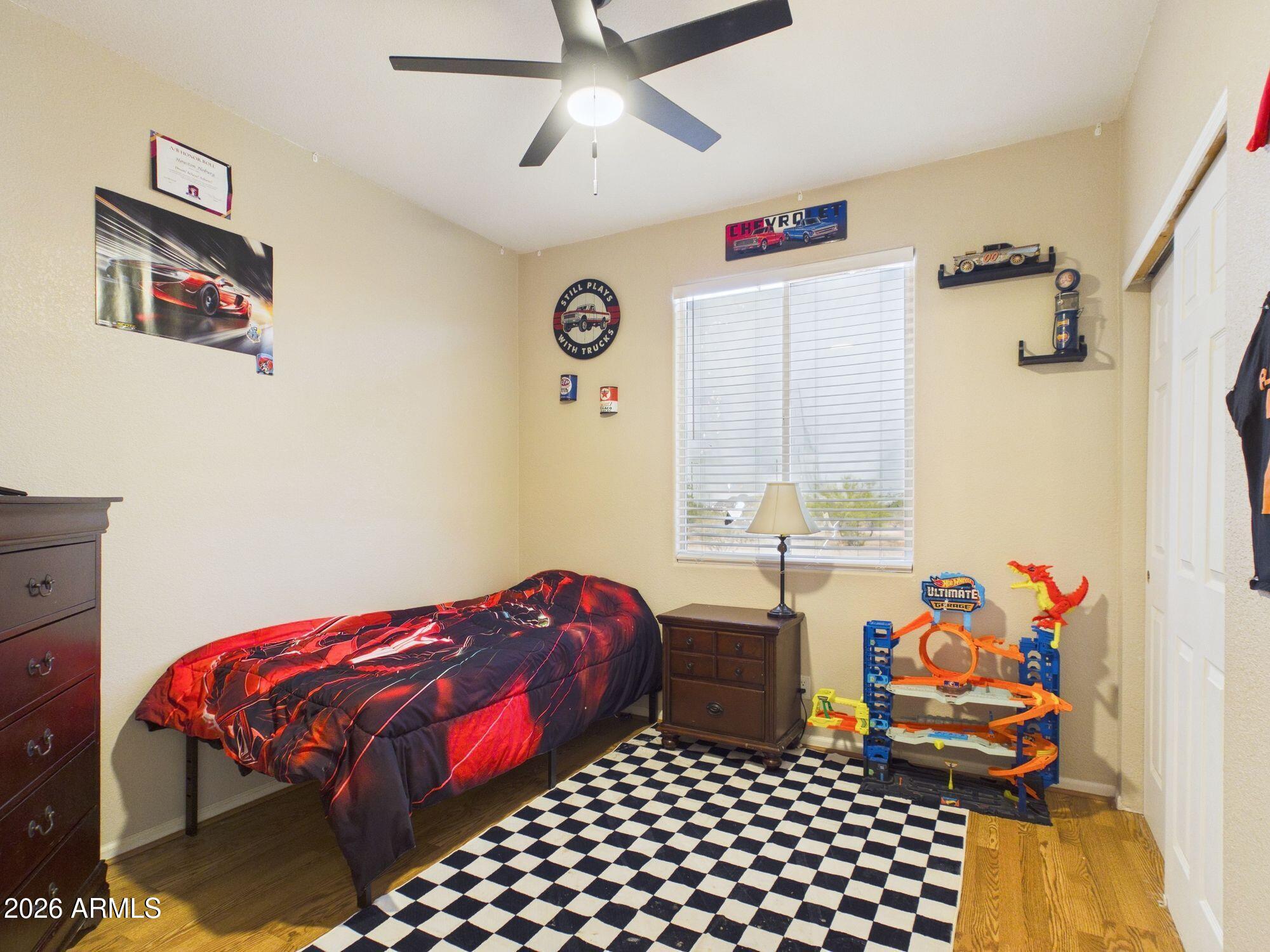 51491 West Dune Shadow Road Maricopa, AZ 85139 - Photo 18 of 33 a bedroom with a bed and a window