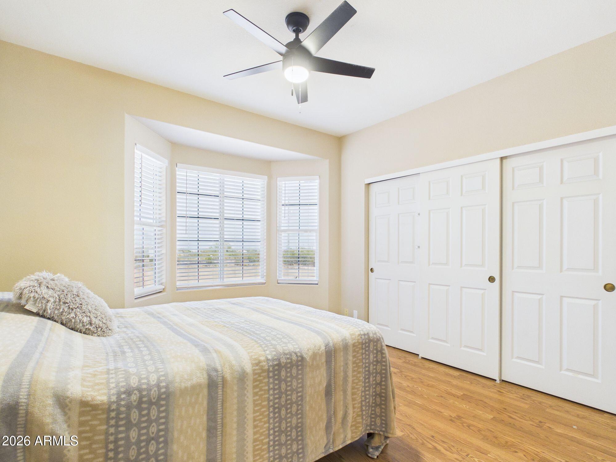 51491 West Dune Shadow Road Maricopa, AZ 85139 - Photo 19 of 33 a spacious bedroom with a bed and a window