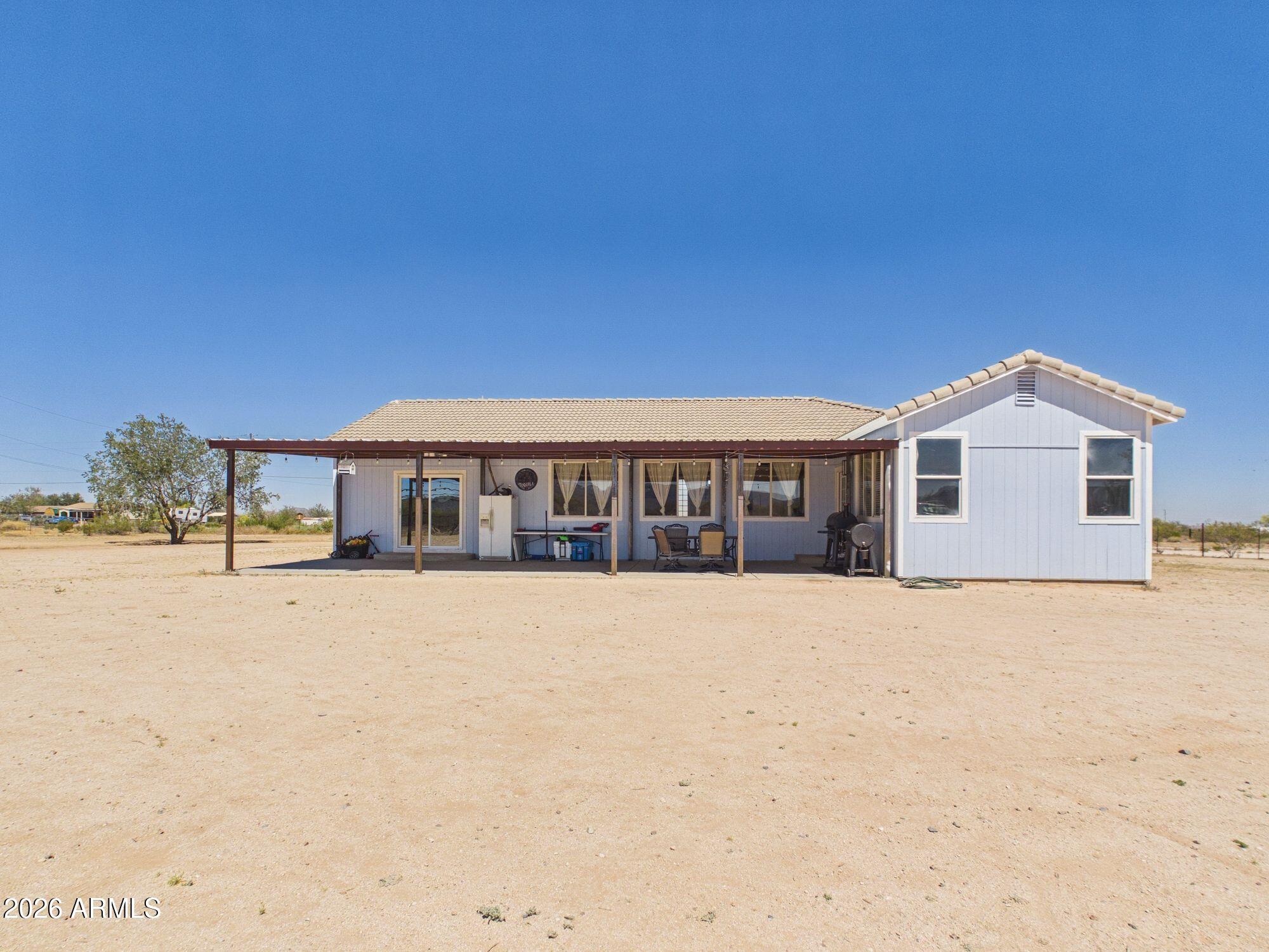 51491 West Dune Shadow Road Maricopa, AZ 85139 - Photo 24 of 33 a front view of house with yard and trees in the background