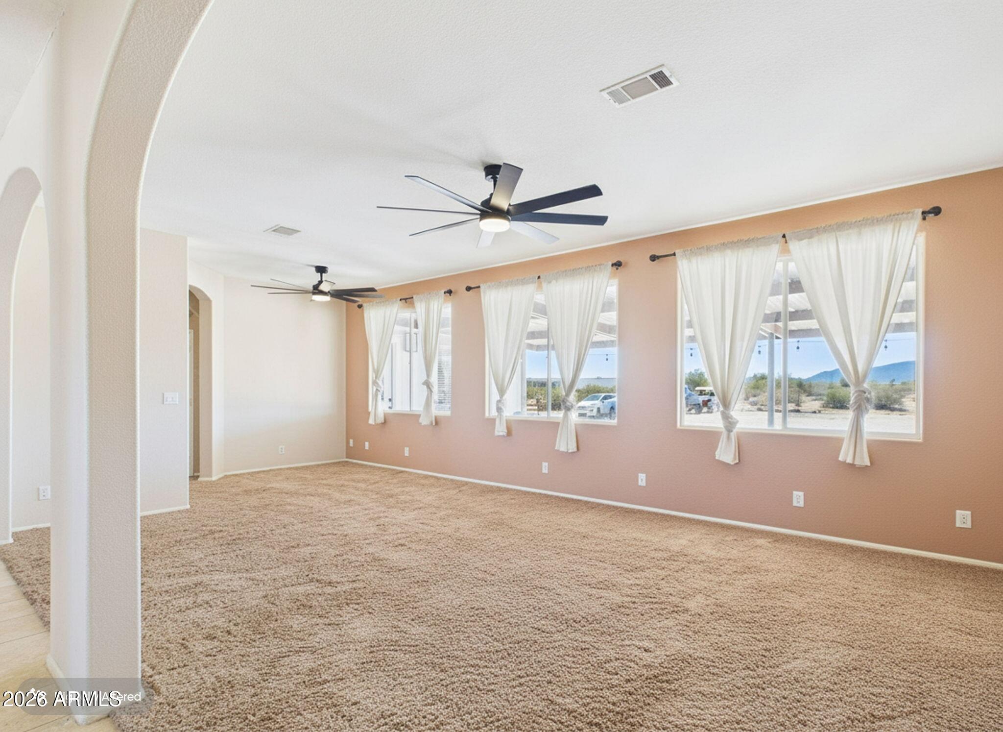 51491 West Dune Shadow Road Maricopa, AZ 85139 - Photo 6 of 33 a view of an empty room with a window