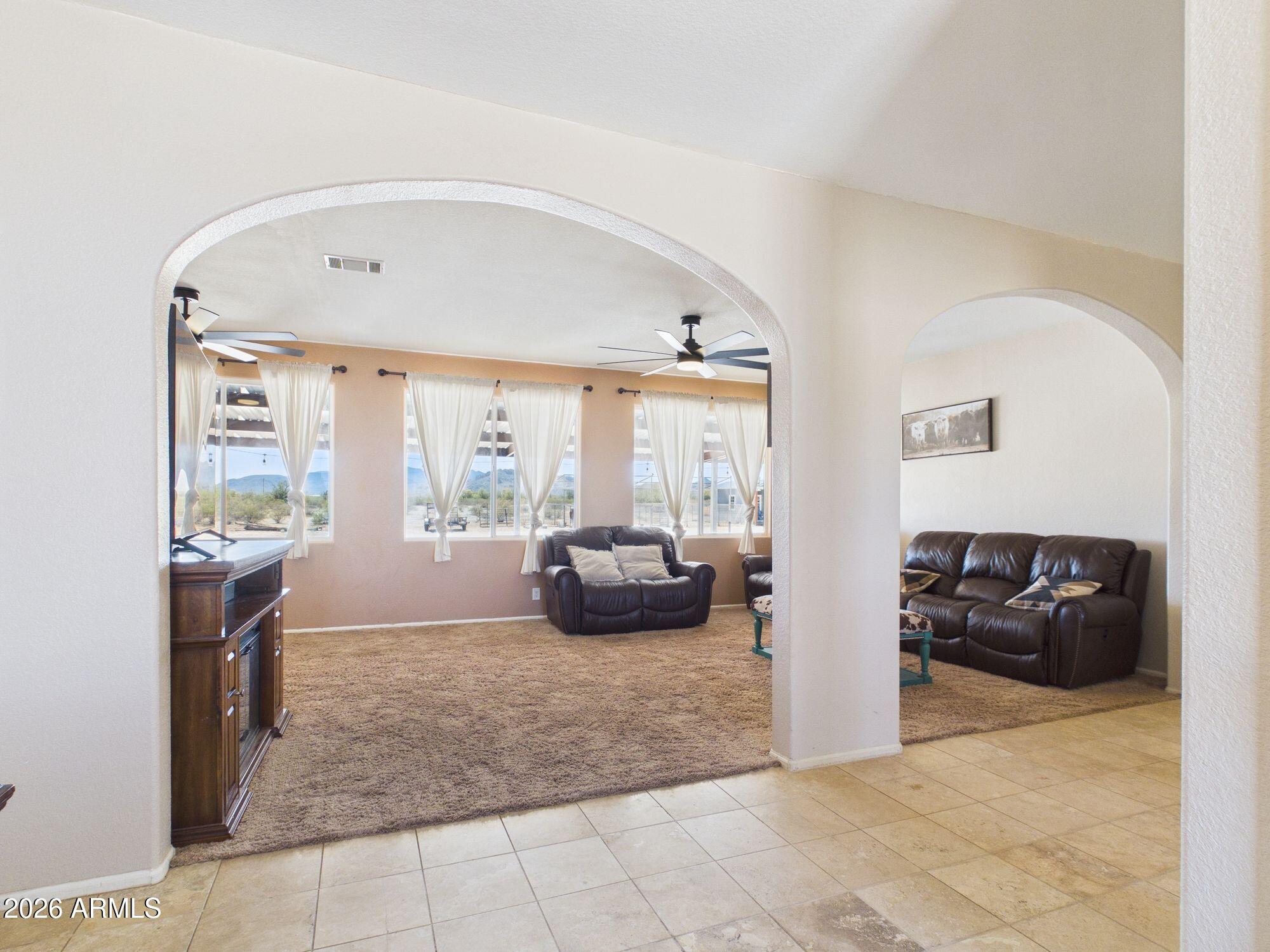 51491 West Dune Shadow Road Maricopa, AZ 85139 - Photo 7 of 33 a living room with furniture and a large window