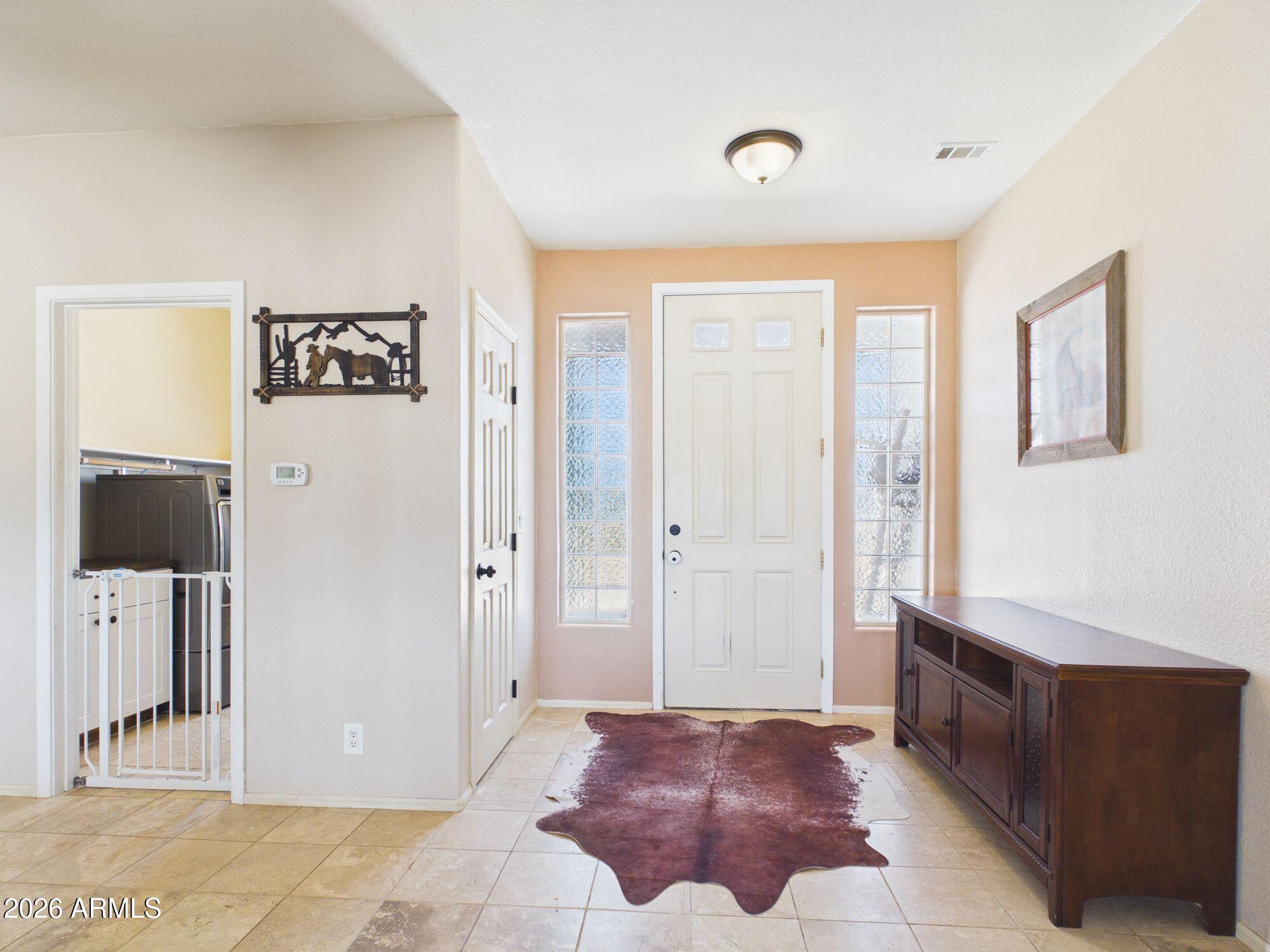 51491 West Dune Shadow Road Maricopa, AZ 85139 - Photo 9 of 33 a spacious bedroom with a bed and a flat screen tv