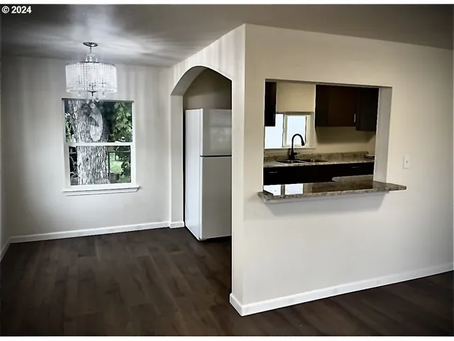 a view of a living room with hardwood floor and a ceiling fan
