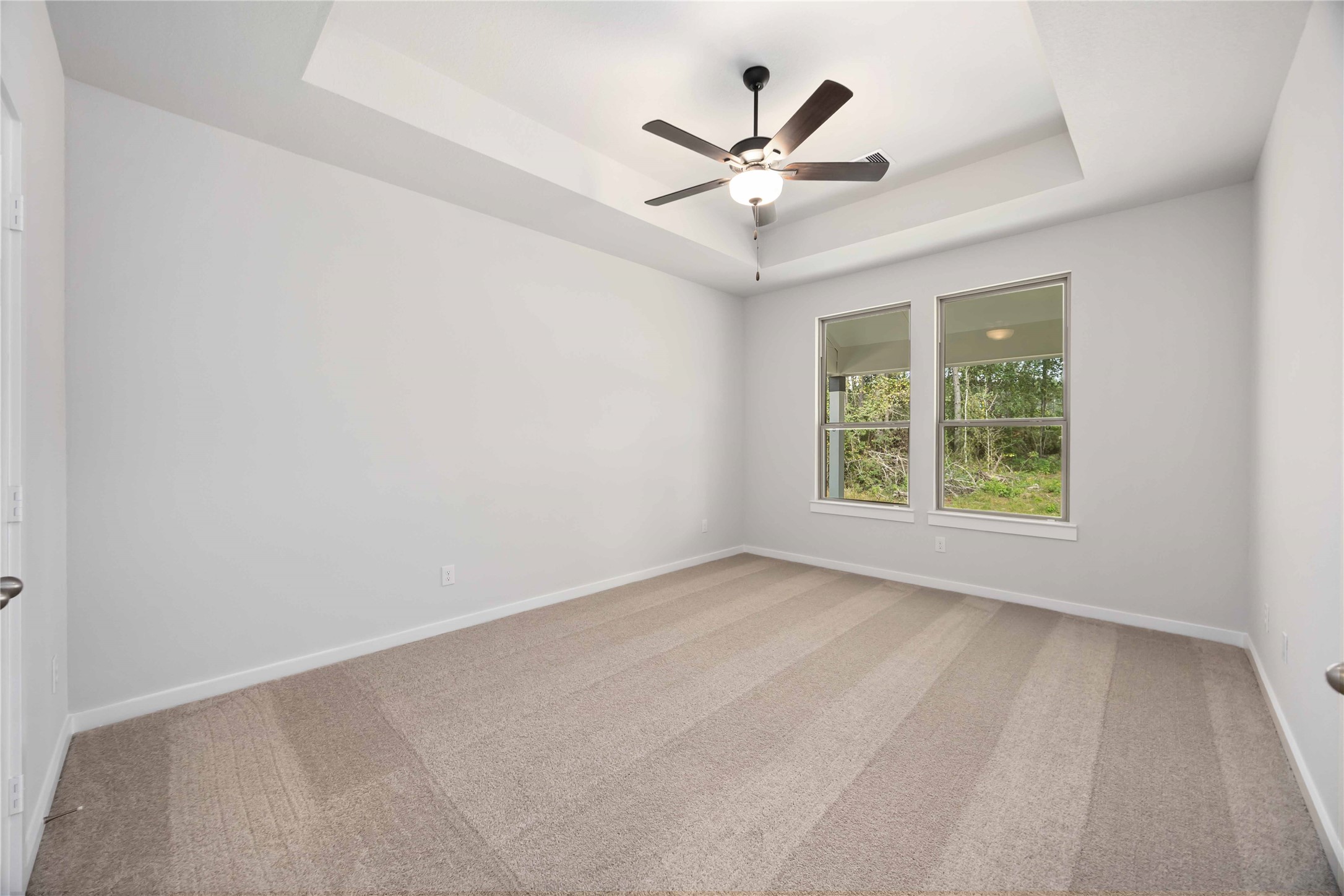 13511 Caldwell Street Conroe, TX 77303 - Photo 11 of 29 an empty room with a window and a fan