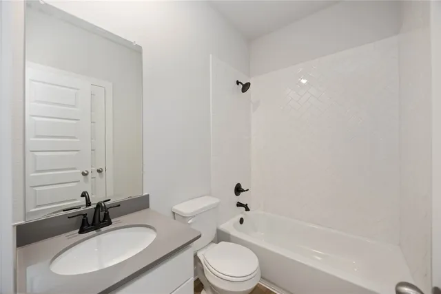 a bathroom with a bathtub shower sink vanity mirror and toilet sink