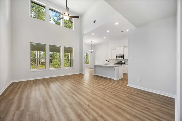 a view of kitchen with granite countertop cabinets and wooden floor