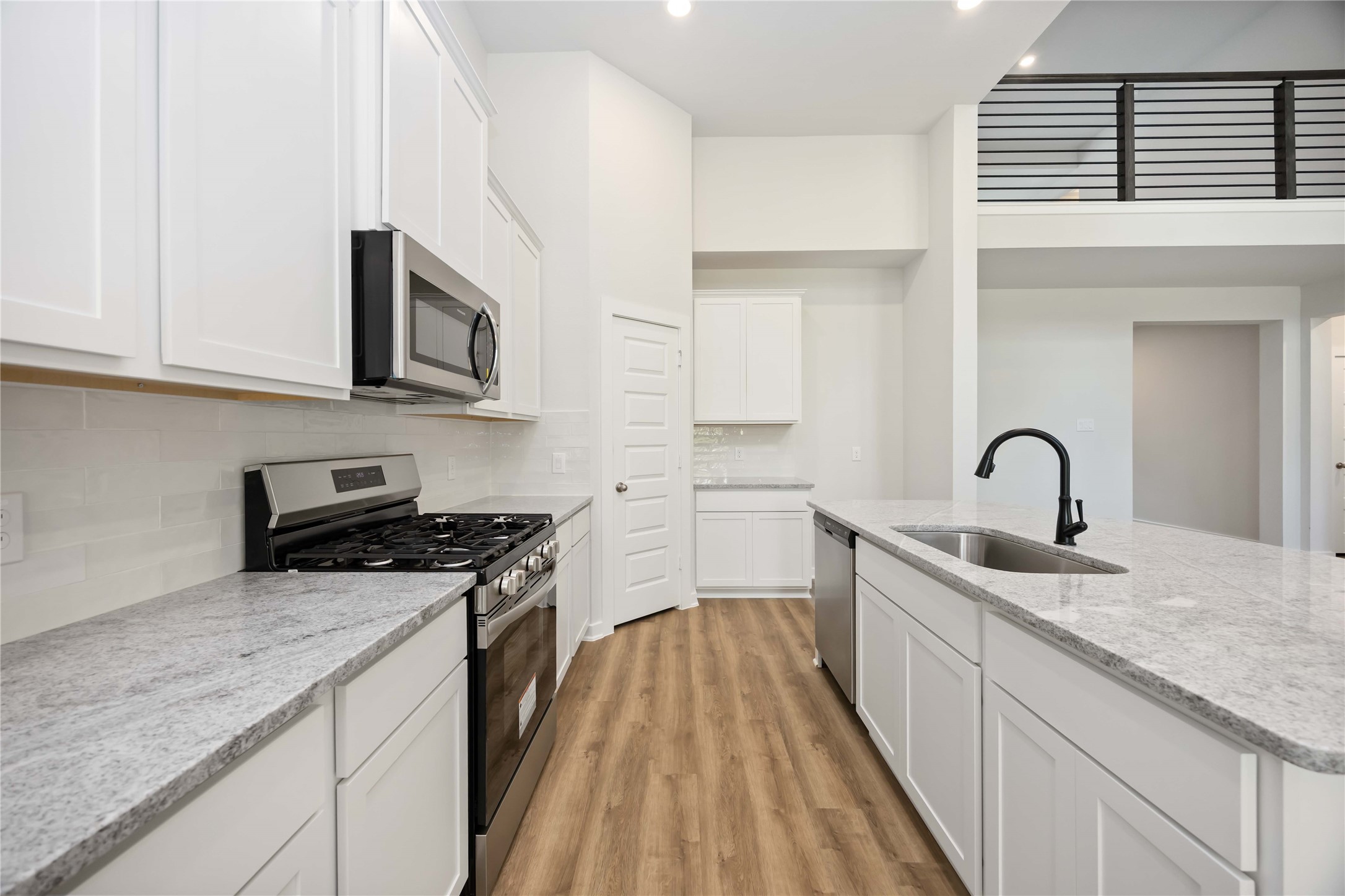 13511 Caldwell Street Conroe, TX 77303 - Photo 8 of 29 a kitchen with stainless steel appliances granite countertop a stove and a sink