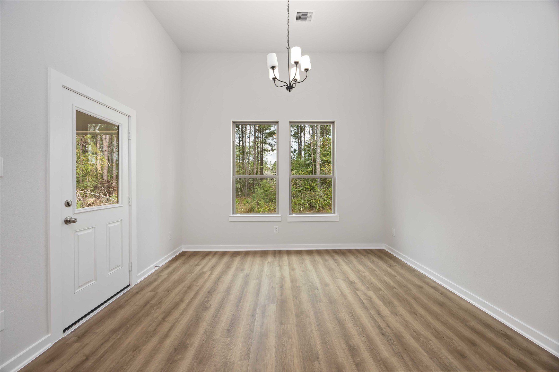 13511 Caldwell Street Conroe, TX 77303 - Photo 10 of 29 wooden floor in an empty room with a window