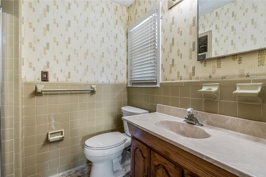 2101 Old Spring Drive Anderson, SC 29625 - Photo 16 of 36 A neatly organized bathroom with classic tile walls and a vanity sink.