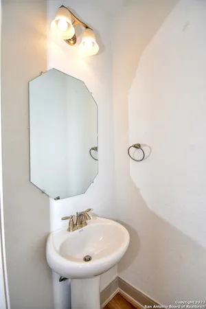 a bathroom with a sink and mirror