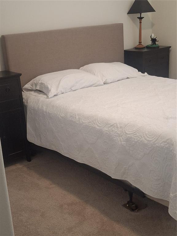 12618 Vander Way New Port Richey, FL 34654 - Photo 18 of 22 a bed sitting in a bedroom and chandelier