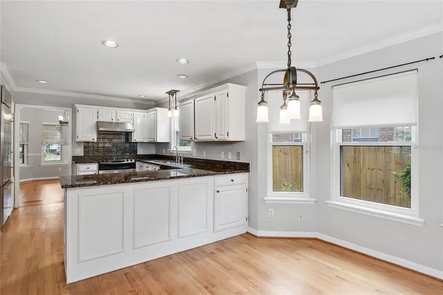 a kitchen with stainless steel appliances granite countertop a stove a sink and a refrigerator