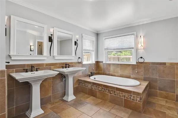 a bathroom with a sink a mirror and a bathtub
