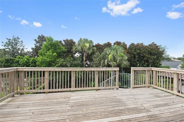a terrace of a house with wooden floor and fence