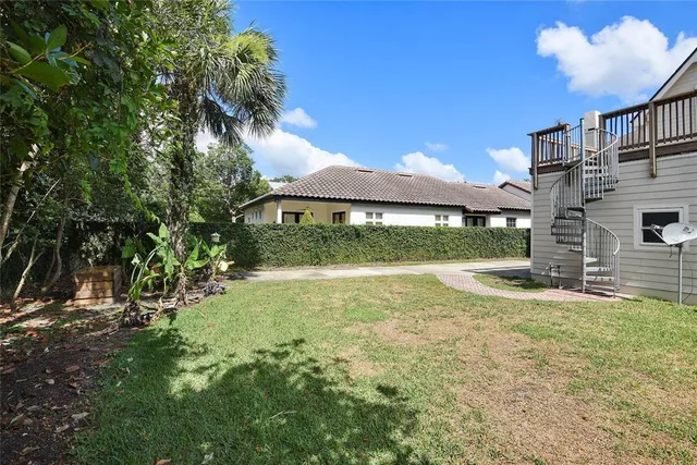 a view of a backyard with a garden and outdoor seating