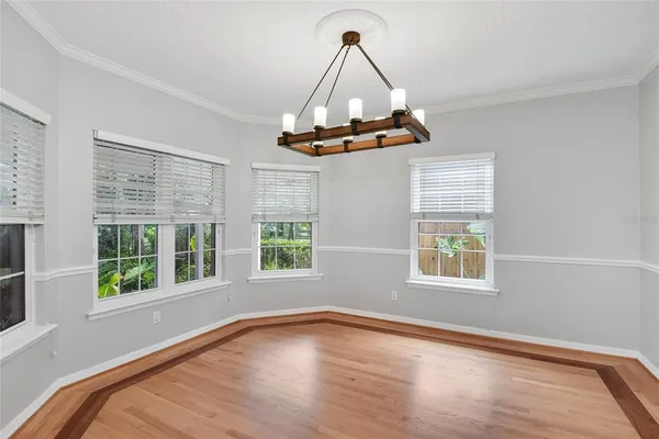 a view of a room with wooden floor and windows