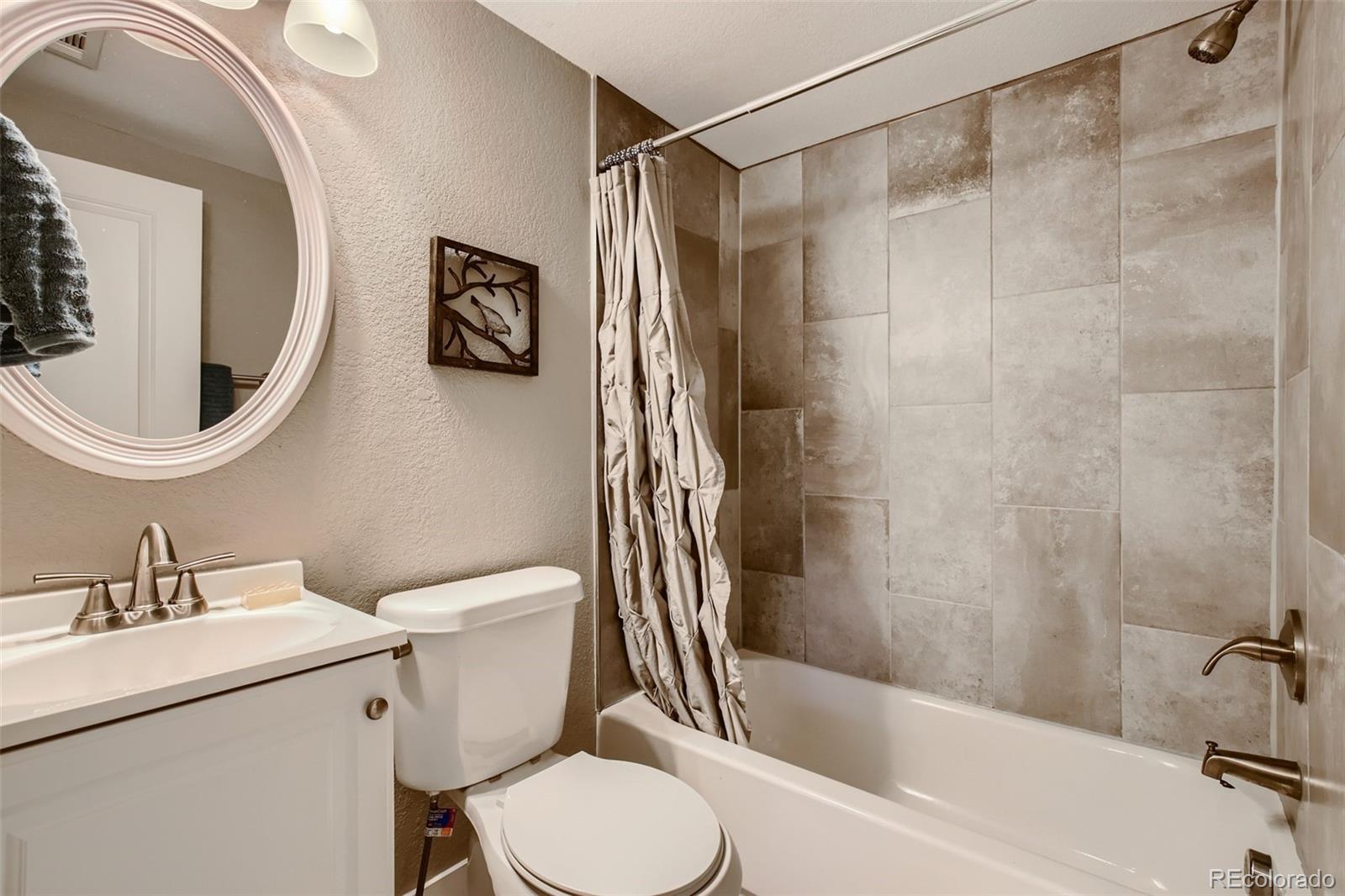 2310 South Decatur Street Denver, CO 80219 - Photo 19 of 27 a bathroom with a sink a toilet and shower