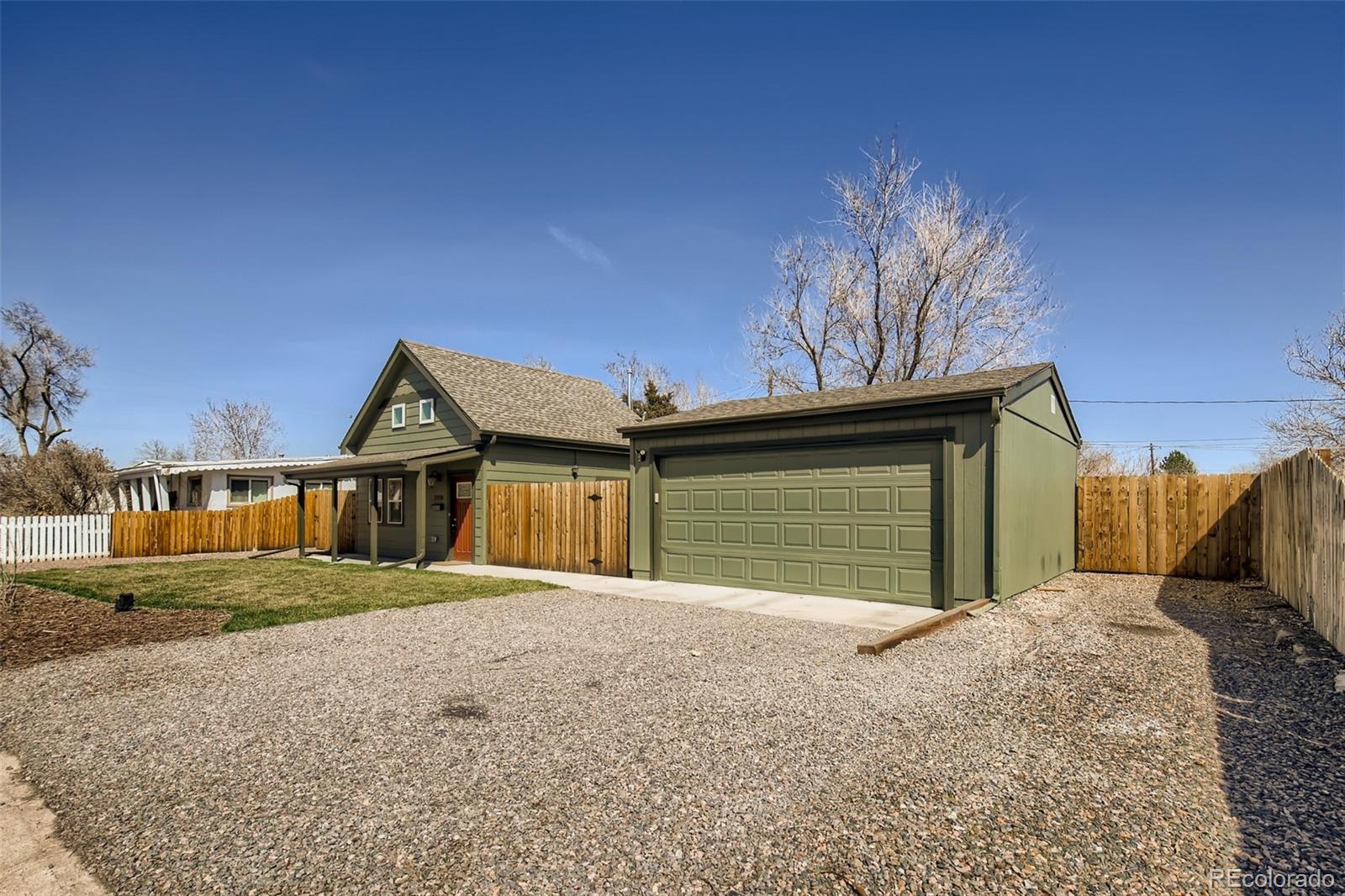 2310 South Decatur Street Denver, CO 80219 - Photo 26 of 27 a front view of a house with a yard and garage