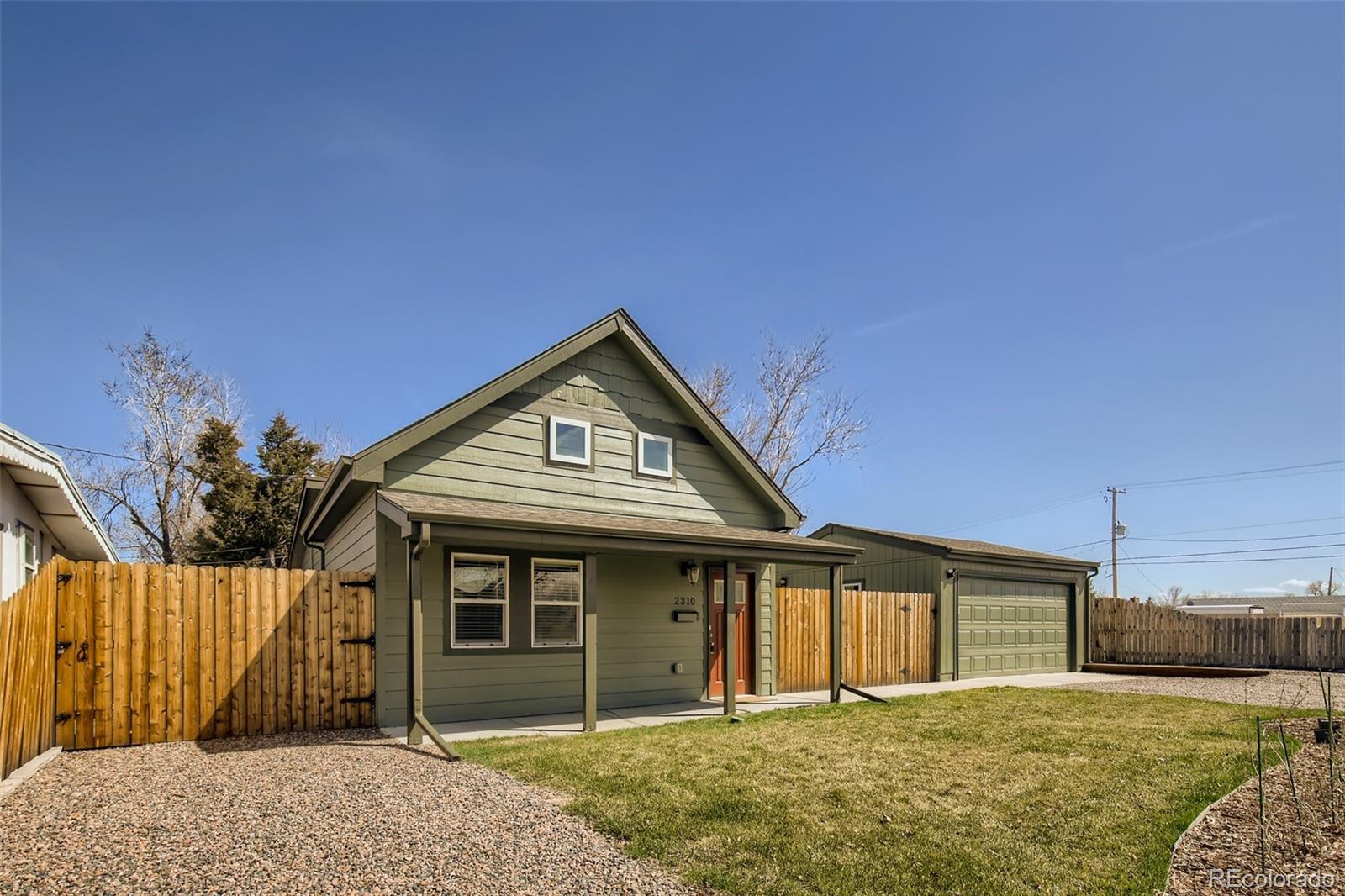 2310 South Decatur Street Denver, CO 80219 - Photo 27 of 27 a front view of a house with a yard and garage