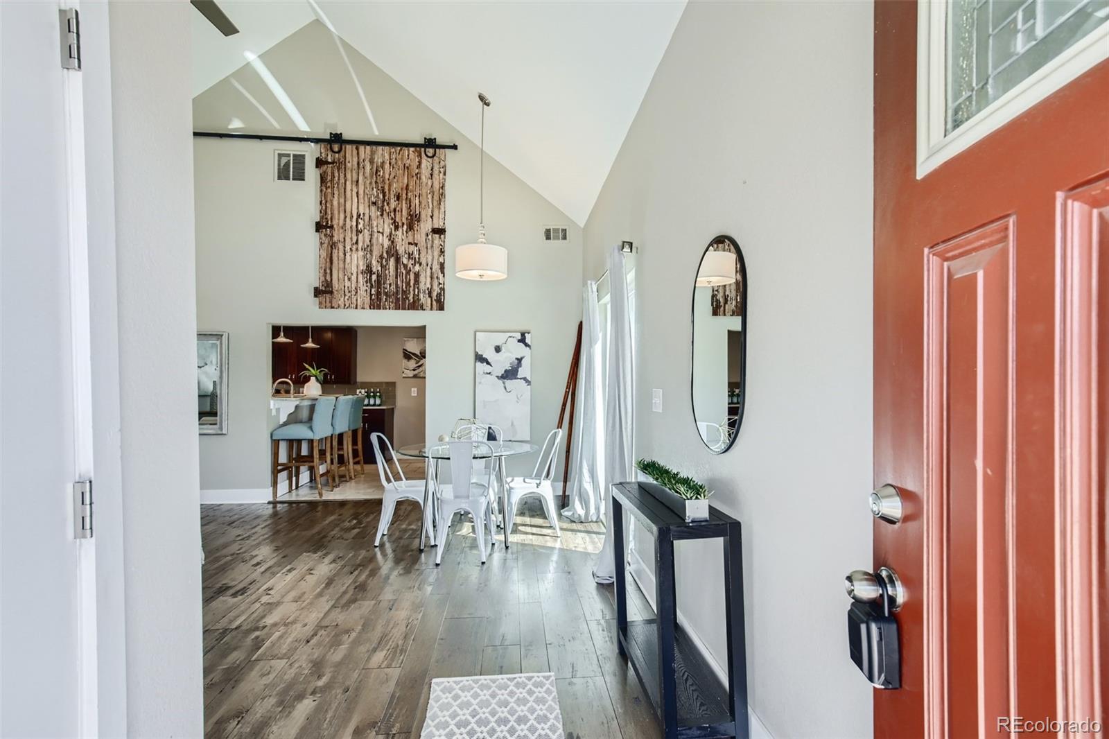 2310 South Decatur Street Denver, CO 80219 - Photo 3 of 27 a view of a hallway with wooden floor and stairs