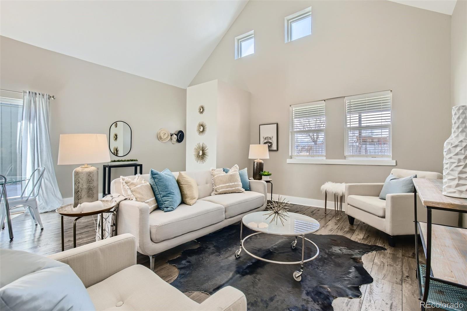 2310 South Decatur Street Denver, CO 80219 - Photo 4 of 27 a living room with furniture a rug and a table