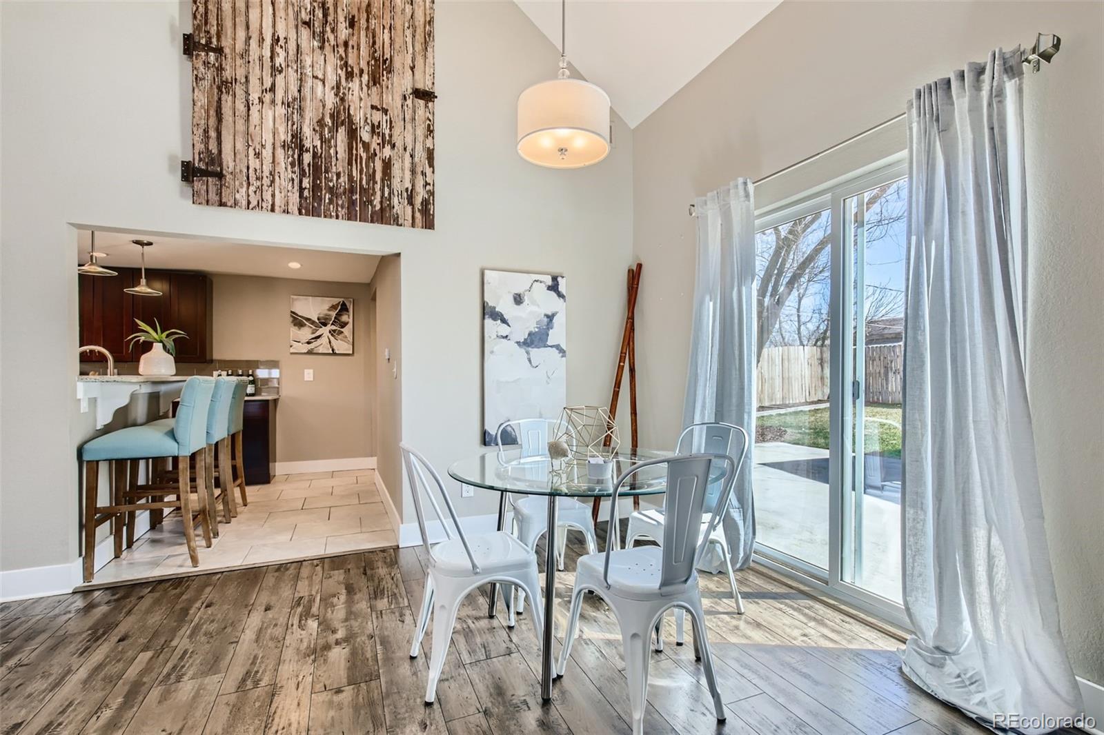 2310 South Decatur Street Denver, CO 80219 - Photo 7 of 27 a view of a dining room with furniture window and wooden floor